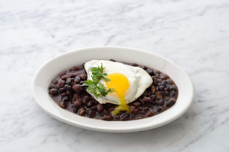 Load image into Gallery viewer, A plate of Fillo's black beans eggs and garnish.