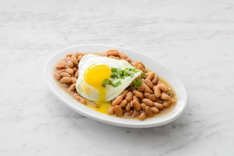 Load image into Gallery viewer, A plate of Mexican Mayocoba Sofrito topped with egg and garnish. 
