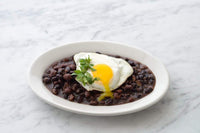 Load image into Gallery viewer, A plate of Fillo&#39;s black beans eggs and garnish. 
