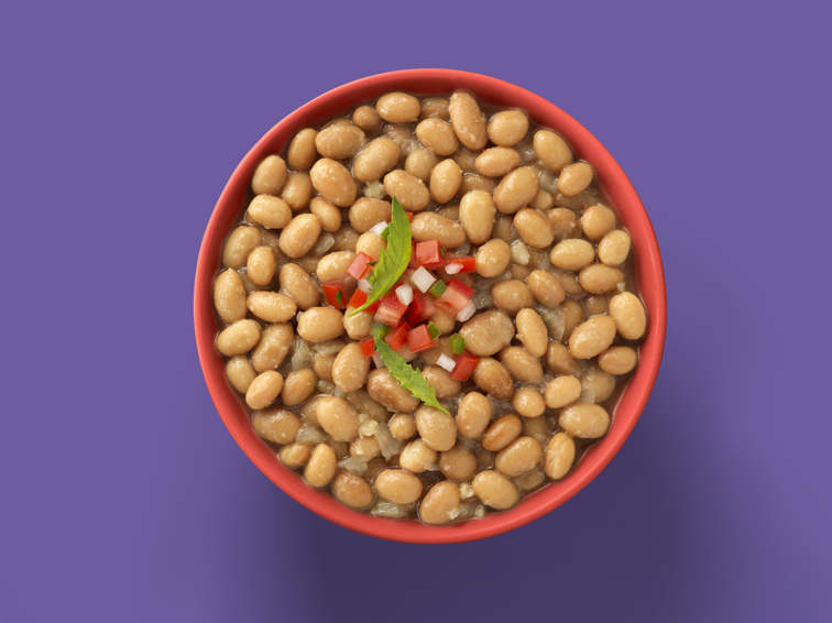 Load image into Gallery viewer, A bowl of beans with tomato, onion, and garnish. 
