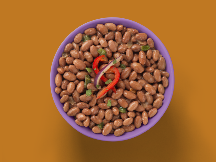 Load image into Gallery viewer, A bowl of beans red peppers, onion, and garnish. 
